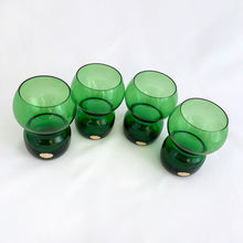 Load image into Gallery viewer, Funky set of four vintage emerald green hand blown glass tumblers. Crafted in Poland, circa 1960s. These glasses feature a bloated hourglass shape. Guaranteed to amp up your bar cart! In excellent condition, free from chips/wear. Original sticker present on each glass, marked "Made in Poland". Measures 2 3/8 x 3 3/8 inches Capacity 6 ounces