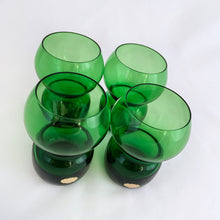 Load image into Gallery viewer, Funky set of four vintage emerald green hand blown glass tumblers. Crafted in Poland, circa 1960s. These glasses feature a bloated hourglass shape. Guaranteed to amp up your bar cart! In excellent condition, free from chips/wear. Original sticker present on each glass, marked "Made in Poland". Measures 2 3/8 x 3 3/8 inches Capacity 6 ounces