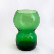 Load image into Gallery viewer, Funky set of four vintage emerald green hand blown glass tumblers. Crafted in Poland, circa 1960s. These glasses feature a bloated hourglass shape. Guaranteed to amp up your bar cart! In excellent condition, free from chips/wear. Original sticker present on each glass, marked "Made in Poland". Measures 2 3/8 x 3 3/8 inches Capacity 6 ounces