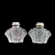 Load image into Gallery viewer, Enhance your tablescape with sparkling vintage brilliant fine cut crystal fan-shaped salt and peppers shakers topped with sterling silver lids inlaid with mother-of-pearl....stunning!
The crystal is in excellent condition, no chips. The sterling silver lids show age related wear. Marked Sterling 925 with hallmark.
Measures 2 x 4 1/2 inches