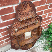 Load image into Gallery viewer, Incredible primitive antique Father Time handmade wood scroll saw wall hung shelf depicting the months of the year with scenes of figures, flora and fauna including birds, rabbits and flowers depicting an activity appropriate to the month, topped with a lounging Father Time with sycthe and hourglass. There are a total of 10 shelves which are notched together and removable, in addition there are 4 mirrors. In as found condition with a corder of the backboard damaged.