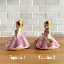 Load image into Gallery viewer, This sweet vintage mid-century figurine is one of the Birthday of the Month series designed by Josef Originals, Japan, 1950s. This sweet black-eyed girl is beautifully styled wearing a full length gown, hand painted in purple with raised flowers, holding a purple flowers with an amethyst birthstone in the centre of the flower. In excellent condition, free from chips/cracks/repairs. Marked on the bottom with the Noritake for Giftcraft mark. Measures 3 1/2 x 4 inches