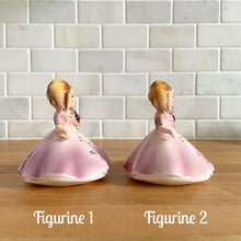 Load image into Gallery viewer, This sweet vintage mid-century figurine is one of the Birthday of the Month series designed by Josef Originals, Japan, 1950s. This sweet black-eyed girl is beautifully styled wearing a full length gown, hand painted in purple with raised flowers, holding a purple flowers with an amethyst birthstone in the centre of the flower. In excellent condition, free from chips/cracks/repairs. Marked on the bottom with the Noritake for Giftcraft mark. Measures 3 1/2 x 4 inches