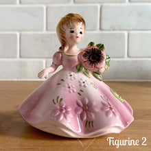 Load image into Gallery viewer, This sweet vintage mid-century figurine is one of the Birthday of the Month series designed by Josef Originals, Japan, 1950s. This sweet black-eyed girl is beautifully styled wearing a full length gown, hand painted in purple with raised flowers, holding a purple flowers with an amethyst birthstone in the centre of the flower. In excellent condition, free from chips/cracks/repairs. Marked on the bottom with the Noritake for Giftcraft mark. Measures 3 1/2 x 4 inches