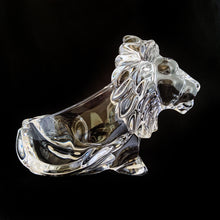 Load image into Gallery viewer, This vintage figural crystal glass seated lion pipe rest is sure to be a conversation starter. Crafted by Art Vannes, France, circa 1960s/70s. With its elegant and powerful presence, this stunning lion may be used as intended, or as a paperweight and candy dish. Whichever your choice, this piece will add an extra touch of sophistication to any corner of your room. In excellent condition, free from chips/wear. Maker's mark on the bottom. Measures 6 3/4 x 2 5/8 x 4 1/2 inches