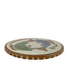 Load image into Gallery viewer, A charming hand painted folk art trivet featuring a whimsical fish design. Crafted by Ken Edwards, La Palomar Pottery, Tonalá, Mexico 1960s. This vintage ceramic piece brings artisanal character to your kitchen while protecting surfaces from heat. Perfect for displaying hot dishes, pots, and pans with a touch of Mexican flair.
In excellent condition, no chips.
Measures 7 3/8 x 1/4 inches