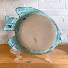 Load image into Gallery viewer, This one-of-a-kind studio art pottery figural fish dish is an exquisite example of artisan craftsmanship. Glazed in an aqua and blue with a textured surface, it's a stunning piece that will bring a splash of beauty to your home. Signed by the artist with the initials "JF," it's perfect for showing off candies and other treats or just adding a touch of beauty to your decor. In excellent condition, free from chips/cracks/repairs. Measures approximately 13 3/4 x 11 x1 3/4 inches