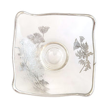 Load image into Gallery viewer, Vintage Flanders clear candy bowl features a silver overlay pattern of poppy flowers. The blank is Viking Glass and the overlay is by Silver City Glass, USA, 1940s. his lovely square bowl with folded corners is perfect for serving candies or to use as a catchall. A lovely way to add a touch of vintage charm to your home or to give as housewarming or wedding gift.
In excellent condition, no chips. Silver is intact.
Measures 6 x 3 inches