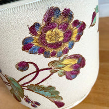 Load image into Gallery viewer, Antique porcelain biscuit jar featuring whimsical florals on a cream ground with silver plated collar, handle and lid. Crafted by Taylor Tunnicliffe, England, 1875 - 1898. Absolutely stunning example of decorative and functional artistry from the Aesthetic Movement era! In overall excellent condition for a piece of its age with wear to the silver plate on the lid and minor discolouration on the porcelain. Measures 5 x 6 5/8 inches (8 1/4 with handle raised)