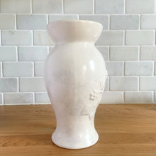 Load image into Gallery viewer, Vintage off-white pale mauve sponge glazed art pottery vase featuring embossed flowers on vine, shape 864. Crafted by Redwing Pottery, USA 1950s. Perfect for creating a beautiful floral arrangement or to use as home decor. A great gift for the art pottery collector. In excellent condition, no chips/cracks/repairs. Measures 4 x 8 inches