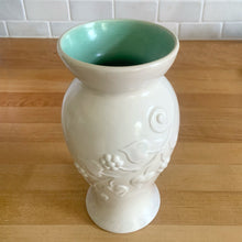 Load image into Gallery viewer, Vintage off-white pale mauve sponge glazed art pottery vase featuring embossed flowers on vine, shape 864. Crafted by Redwing Pottery, USA 1950s. Perfect for creating a beautiful floral arrangement or to use as home decor. A great gift for the art pottery collector. In excellent condition, no chips/cracks/repairs. Measures 4 x 8 inches