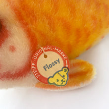 Load image into Gallery viewer, Close-up of the original round red, blue, and yellow 'Flossy' paper chest tag.