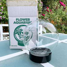 Load image into Gallery viewer, Funky vintage retro glass flower aquarium. Preserve your flowers with this glass globe using only water and vinegar. Regal Greetings and Gift, made in Germany, 1970s. The 7 stem holders in the rubber gasket allow you to create a indoor garden oasis with the illusion of magnified floral display...so cool! Easily repurpose as a display piece by filling it with lights or a collection of Christmas ornaments. New old stock, in the original box. In excellent condition. Measures 5 1/2 x 7 inches