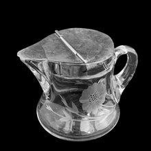 Load image into Gallery viewer, Sweet vintage cut crystal syrup pitcher featuring cut flowers and stems with removable metal hinged lid and applied blown handle. Crafted by Heisey Glass, USA, circa 1920s. A beautiful addition to your tablescape!
In great vintage condition, no chips, wear to the lid.
Measures 3 1/8 x 3 inches