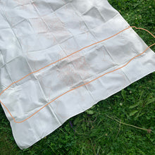 Load image into Gallery viewer, Vintage Indian Head 100% cotton tablecloth with a stamped pattern of flowers and cattails. These Bucilla kit tablecloths were intended to be painted with Tri-Chem Liquid Embroidery pens, but can easily be stitched with embroidery floss to create a beautiful table covering. In as found vintage condition with staining, see photos. Comes with original instruction sheet. Measures 54 x 72 inches