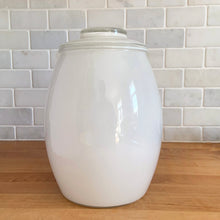 Load image into Gallery viewer, Vintage mid-century white glass lidded canister or cookie jar hand painted with flowers and fruits. Crafted by Bartlett Collins, 1960s. A nice sized and pretty jar to store cookies or dry goods.
In excellent condition, no chips, minor wear to the gold.
Measures 7 x 9 1/2 inches