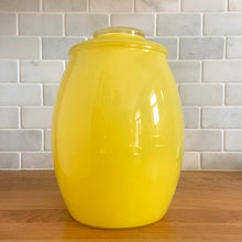 Load image into Gallery viewer, Vintage mid-century yellow glass lidded canister or cookie jar hand painted with flowers and fruits. Crafted by Bartlett Collins, 1960s. A nice sized and pretty jar to store cookies or dry goods.
In good vintage condition, no chips, age-related wear to the gold.
Measures 7 x 9 1/2 inches