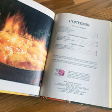 Load image into Gallery viewer, Better Homes and Gardens is known for its fabulous cookbooks. This hardcover cookbook focuses on fondue and tabletop cooking inspired recipes. Its 96 pages are filled with amazing recipes along with many colour photographs. Originally published by Meredith Corporation, USA, 1970. First edition, eleventh printing 1973. In great vintage condition with normal age-related yellowing.
