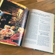 Load image into Gallery viewer, Better Homes and Gardens is known for its fabulous cookbooks. This hardcover cookbook focuses on fondue and tabletop cooking inspired recipes. Its 96 pages are filled with amazing recipes along with many colour photographs. Originally published by Meredith Corporation, USA, 1970. First edition, eleventh printing 1973. In great vintage condition with normal age-related yellowing.