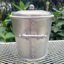 Load image into Gallery viewer, Vintage mid-century era Roses hand forged hammered aluminum ice bucket featuring two stylized handles, an embossed rose sprays on each side of the bucket plus a wreath of roses on the lid circling the decorative knob. Crafted by the Everlast Metal Products Corporation, USA, 1950s. Includes a decorative hammered aluminum slotted ice spoon. The perfect addition to your bar cart!
In used vintage condition with age-appropriate wear. Measures 8 x 8 x 9 1/2 inches