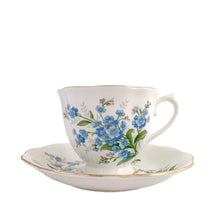 Load image into Gallery viewer, Vintage Avon shaped Forget-Me-Not bone china teacup and saucer, features a scalloped edge with hand painted blue flowers and gold gilt rim. Royal Albert, England, 1950s. In excellent condition, free from chips, cracks and repairs. Makers marks present. Teacup measures 3 1/4 x 2 3/4 inches | Saucer measures 5 1/2 inches