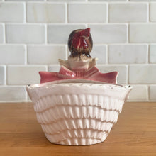 Load image into Gallery viewer, Adorable vintage mid-century era girl in a yellow dress ceramic planter 502. Crafted by Rubens Originals, Japan, 1950s. Use for tiny plants or repurpose to hold accessories.
In as found vintage condition, bow is chipped at the back, no cracks/repairs.
Measures 4 1/2 x 4 x 4 1/2 inches