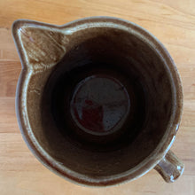 Load image into Gallery viewer, Vintage gloss brown stoneware pitcher with stacked chevron detail. Crafted by Monmouth Western Stoneware, USA, 1920s. Add this utilitarian piece to your farmhouse decor or art pottery collection!
In excellent vintage condition, no chips/cracks/repairs, age-related crazing. Unmarked.
Measures 4 1/2 x 5 inches