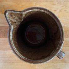 Load image into Gallery viewer, Vintage gloss brown stoneware pitcher with stacked chevron detail. Crafted by Monmouth Western Stoneware, USA, 1920s. Add this utilitarian piece to your farmhouse decor or art pottery collection!
In excellent vintage condition, no chips/cracks/repairs, age-related crazing. Unmarked.
Measures 4 1/2 x 5 inches