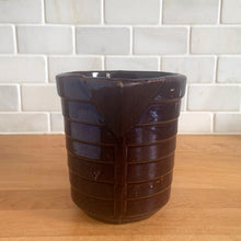Load image into Gallery viewer, Vintage glossy deep brown stoneware pitcher with horizontal ribbed detail. Crafted by Monmouth Western Stoneware, USA, 1920s. Add this utilitarian piece to your farmhouse decor or art pottery collection!
In excellent condition, no chips/cracks/repairs, age-related crazing. Unmarked.
Measures 4 1/2 x 5 inches