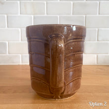 Load image into Gallery viewer, Vintage gloss brown stoneware pitcher with stacked chevron detail. Crafted by Monmouth Western Stoneware, USA, 1920s. Add this utilitarian piece to your farmhouse decor or art pottery collection!
In as found vintage condition, chip to the spout, no cracks/repairs, age-related crazing. Unmarked.
Measures 4 1/2 x 5 inches