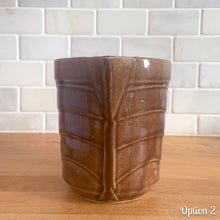 Load image into Gallery viewer, Vintage gloss brown stoneware pitcher with stacked chevron detail. Crafted by Monmouth Western Stoneware, USA, 1920s. Add this utilitarian piece to your farmhouse decor or art pottery collection!
In as found vintage condition, chip to the spout, no cracks/repairs, age-related crazing. Unmarked.
Measures 4 1/2 x 5 inches
