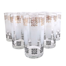Load image into Gallery viewer, Sip in style with vintage mid-century highball cocktail glass tumblers featuring gold and black atomic style flowers with frosted bands! These elegant glasses from the Libbey Glass Company, USA, circa 1950s are sure to make a statement at your next dinner party. Enjoy the unique blend of classic mid-century style and modern vibrancy in each glass!