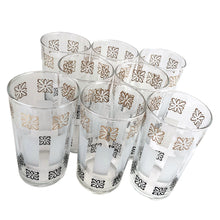 Load image into Gallery viewer, Sip in style with vintage mid-century highball cocktail glass tumblers featuring gold and black atomic style flowers with frosted bands! These elegant glasses from the Libbey Glass Company, USA, circa 1950s are sure to make a statement at your next dinner party. Enjoy the unique blend of classic mid-century style and modern vibrancy in each glass!