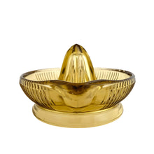 Load image into Gallery viewer, Vintage gold vertically ribbed citrus reamer with spout and finger handle. Crafted by Anchor Hocking, 1950/60s. The perfect accessory for kitchen and bar for fresh squeezed orange, lemon and lime juice...no sugar added!
In vintage condition, rough mold release at the spout, chip to the underside interior rim.
Measures 6 x 8 1/2 x 4 inches (incl. handle/spout)