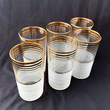 Load image into Gallery viewer, Angled overhead view of 1950s frosted cocktail glasses with graduating gold bands mid-century barware