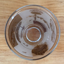 Load image into Gallery viewer, A chilled cocktail would complement this vibrant vintage Golden Meadow highball glass tumbler featuring 22kt gold. Designed by Fred Press and produced by the Federal Glass, USA, circa 1960-70. The gold butterfly and botanical details pop off the frosted background.
In excellent condition, no chips, minor spot of wear on one glass.
Measures 2 3/4 x 5 1/8 inches