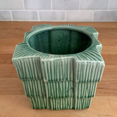 Vintage pink art pottery planter pot featuring a ribbed design and attached underplate. Crafted by McCoy Pottery, USA, circa 1940s. A collectible art pottery planter is perfect for a tiny houseplant, succulents or as part of your McCoy collection!  In vintage condition, chips, see photos for details. Normal crazing present.  Measures 4 1/2 x 4 1/2 x 3 7/8 inches