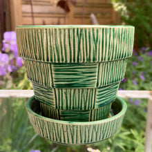 Load image into Gallery viewer, Highly collectible vintage mid-century green basketweave ceramic art pottery planter with attached underplate. Crafted by McCoy Pottery, USA, 1950s. The perfect home for your favourite houseplant or succulent. Makes a lovely gift for any gardening enthusiast.
In excellent vintage condition, no chips/cracks/repairs, age-related crazing. Maker's mark.
Measures 5 1/4 x 4 7/8 inches