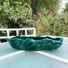 Load image into Gallery viewer, This large vintage ceramic planter features a sculpted wave pattern glazed in deep green drip glaze. Marked "Made in Canada" with the shape number C217. It's the perfect vessel to showcase your favourite houseplants or succulents. In great vintage condition with one minor flea bite on the rim, otherwise no issues. Measures 15 x 6 x 3 1/4 inches