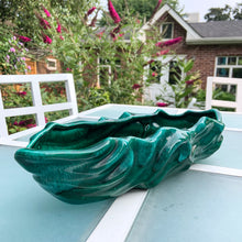 Load image into Gallery viewer, This large vintage ceramic planter features a sculpted wave pattern glazed in deep green drip glaze. Marked "Made in Canada" with the shape number C217. It's the perfect vessel to showcase your favourite houseplants or succulents. In great vintage condition with one minor flea bite on the rim, otherwise no issues. Measures 15 x 6 x 3 1/4 inches