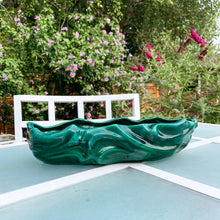 Load image into Gallery viewer, This large vintage ceramic planter features a sculpted wave pattern glazed in deep green drip glaze. Marked "Made in Canada" with the shape number C217. It's the perfect vessel to showcase your favourite houseplants or succulents. In great vintage condition with one minor flea bite on the rim, otherwise no issues. Measures 15 x 6 x 3 1/4 inches