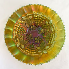 Load image into Gallery viewer, Antique Grape and Cable iridescent green carnival glass bowl featuring a basketweave pattern on the exterior, a smooth sawtooth ruffled pie crust edge and collar base. Crafted by Northwood Glass Company, USA, early 1900s. A lovely vintage piece to display or use as a candy dish!
In excellent condition, no chips. Marked on the bottom with Northwood N with underline inside a circle.
Measures 8 3/8 x 2 1/4 inches