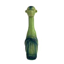 Load image into Gallery viewer, Rare vintage art deco figural smiling and wide eyed seated monkey ceramic long neck flask or decanter, glazed in green and navy blue. Crafted by Schafer and Vater, Germany, circa 1930s. This decanter is reminiscent of a Dr. Seuss-like character, and would be a statement piece for any barware collection! In excellent condition. Crazing present. Measures 2 1/2 x 3 x 10 inches tall