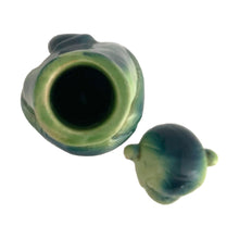 Load image into Gallery viewer, Rare vintage art deco figural smiling and wide eyed seated monkey ceramic long neck flask or decanter, glazed in green and navy blue. Crafted by Schafer and Vater, Germany, circa 1930s. This decanter is reminiscent of a Dr. Seuss-like character, and would be a statement piece for any barware collection! In excellent condition. Crazing present. Measures 2 1/2 x 3 x 10 inches tall