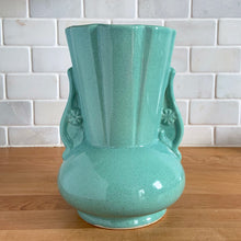 Load image into Gallery viewer, Vintage Art Deco green speckle glazed ceramic flower vase featuring a round base and a ribbed panel design flanked by two handles highlighted with a flower motif. Crafted by York Pottery (precursor to Pfaltzgraff), USA, circa 1930s. A beautiful piece to add to any art pottery collection! Excellent condition. Marked with impressed keystone, York P 288 USA. Measures 5 x 8 inches