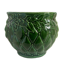 Load image into Gallery viewer, Large vintage TIerra Cushion jardiniere planter pot 1480, deep green shiny glaze, features an overlapping floral leaf pattern around the top rim, a diamond quilted body and ribbon handles. Crafted by McCoy Pottery during the Lancaster Colony Corporation Era, USA, 1974 - 1985. A must-have for any McCoy collector or gardener!
In excellent condition, free from chips, cracks or repairs, with a tiny manufacturer's defect, see photo. Maker's mark is on the bottom. Produced Measures 10 1/4 x 8 3/4 inches