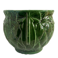 Load image into Gallery viewer, Large vintage TIerra Cushion jardiniere planter pot 1480, deep green shiny glaze, features an overlapping floral leaf pattern around the top rim, a diamond quilted body and ribbon handles. Crafted by McCoy Pottery during the Lancaster Colony Corporation Era, USA, 1974 - 1985. A must-have for any McCoy collector or gardener!
In excellent condition, free from chips, cracks or repairs, with a tiny manufacturer's defect, see photo. Maker's mark is on the bottom. Produced Measures 10 1/4 x 8 3/4 inches