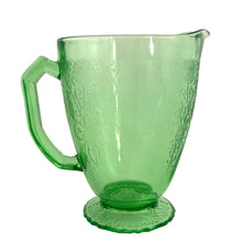 Load image into Gallery viewer, Vintage Florentine 1 green uranium depression era glass 36oz pitcher features a scalloped foot and glows beautifully under black light. Crafted by Hazel-Atlas Glass, USA, 1932 - 1935. Perfect for adding a touch of sophistication to any table setting or display in your uranium glass collection!
In excellent used vintage condition, no chips, minor wear.
Measures 7 x 4 7/8 x 6 3/4 inches (incl. handle/spout)