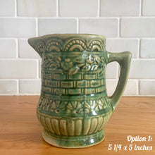 Load image into Gallery viewer, Antique vintage art deco gloss green Rosella 320 ceramic yellow ware pitcher featuring climbing roses on a basketweave pattern. Crafted by Robinson Clay Product Company, the precursor to Robinson Ransbottom Pottery, USA, early 1900s. A beautiful piece to add to your art pottery collection! Option 1, 5 1/4 x 5 inches
In as found vintage condition, no chips/repairs, tiny crack at the spout, age-related crazing. Typical manufacturing glaze pops. Unmarked.