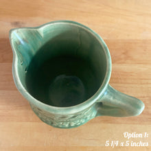 Load image into Gallery viewer, Antique vintage art deco gloss green Rosella 320 ceramic yellow ware pitcher featuring climbing roses on a basketweave pattern. Crafted by Robinson Clay Product Company, the precursor to Robinson Ransbottom Pottery, USA, early 1900s. A beautiful piece to add to your art pottery collection! Option 1, 5 1/4 x 5 inches
In as found vintage condition, no chips/repairs, tiny crack at the spout, age-related crazing. Typical manufacturing glaze pops. Unmarked.